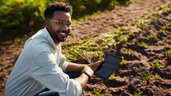 Man leaning down into soil